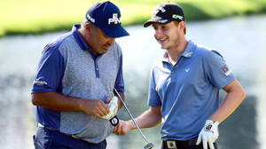 Professional Golfer Emiliano Grillo Skillfully Swings His Club On A Sunlit Course Wallpaper