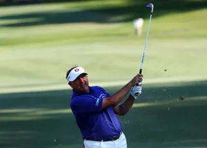 Professional Golfer Ken Duke Swings His Club On The Golf Course Wallpaper