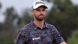 Professional Golfer Wyndham Clark In Full Swing Wallpaper
