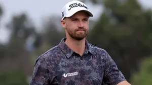 Professional Golfer Wyndham Clark In Full Swing Wallpaper