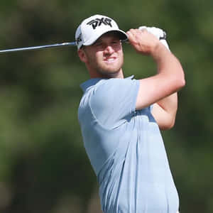 Professional Golfer Wyndham Clark Swinging His Club Wallpaper