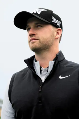 Professional Golfer Wyndham Clark Swinging On The Green Wallpaper