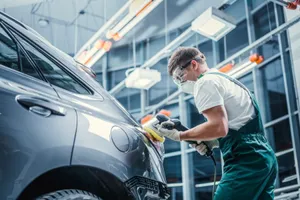 Professional Mechanic Repairing A Car In A Garage Wallpaper