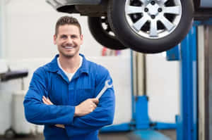 Professional Mechanic Repairing A Car In Garage Wallpaper