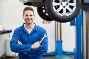 Professional Mechanic Repairing A Car In Garage Wallpaper