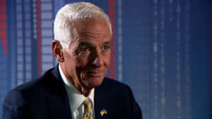 Professional Portrait Of Charlie Crist Against A Blue Background Wallpaper