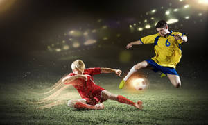 Professional Soccer Players Competing On The Field. Wallpaper