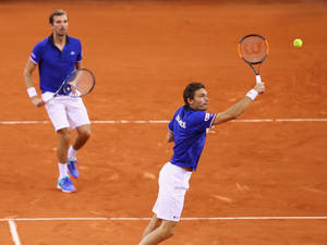 Professional Tennis Player Nicolas Mahut In Doubles Game Action Wallpaper