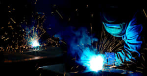 Professional Welder Working On A Joint Wallpaper