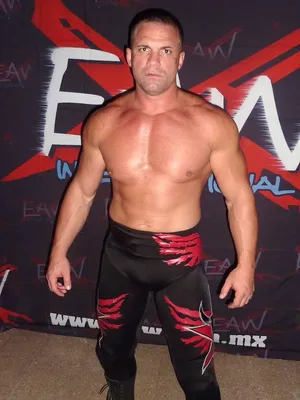 Professional Wrestler Posing Red Black Attire Wallpaper