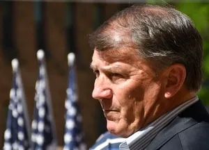 Profileof Manwith Flags Background Wallpaper