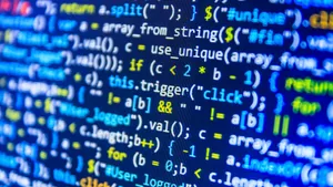 Programmer Working On Coding Tasks On His Laptop Wallpaper