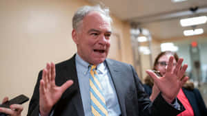 Prominent American Politician Tim Kaine In A Striped Tie. Wallpaper