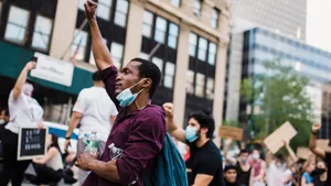 Protestor Raising Fist During Demonstration.jpg Wallpaper