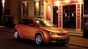 Proton Performance Car In Motion On A Mountain Road Wallpaper