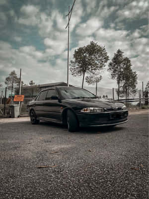 Proton Wira Black Sedan Parked Outdoors Wallpaper
