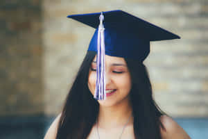 Proud Graduates Celebrating Their Success At A Graduation Ceremony Wallpaper