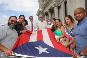 Puerto Rican Flag Hold By People Wallpaper