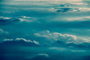 Puffy Teal Clouds Wallpaper