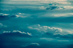 Puffy Teal Clouds Wallpaper