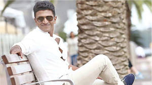 Puneeth Rajkumar On Bench Wallpaper