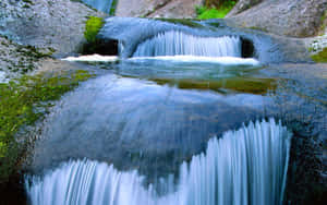 Pure Spring Water Flowing Over Rocks Wallpaper