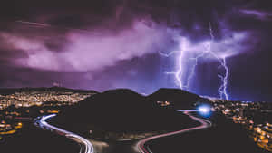 Purple Lightning Over City Road Wallpaper