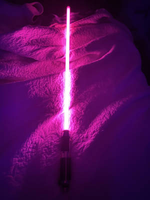 Purple Lightsaber On A Blanket Wallpaper