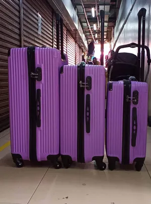 Purple Luggage Set Displayed Wallpaper
