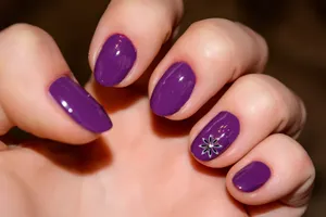 Purple Manicurewith Flower Accent Nail Wallpaper