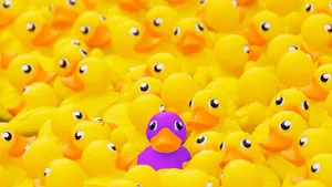 Purple Rubber Duck Among Yellows Wallpaper