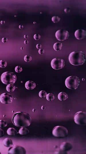 Purple Water Drops On A Black Background Wallpaper