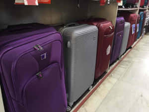 Purpleand Silver Suitcases Display Wallpaper