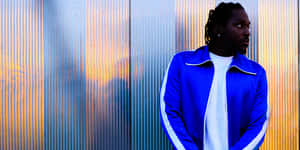 Pusha T Blue Jacket Metallic Backdrop Wallpaper