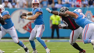 Quarterback Action During Football Game Wallpaper