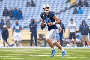 Quarterback Drake Maye In Action Wallpaper