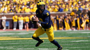 Quarterback In Actionat Football Game Wallpaper