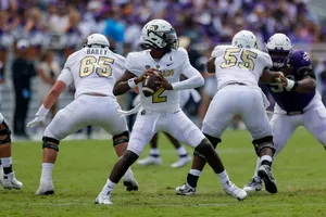 Quarterback Preparesto Pass During Game Wallpaper