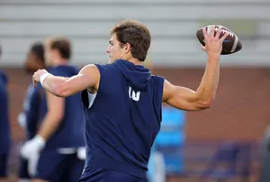 Quarterback Preparingfor Pass Practice Session Wallpaper