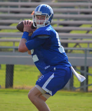 Quarterback Preparingto Throw Football Wallpaper