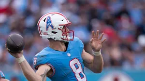 Quarterback Throwing Football Action Wallpaper