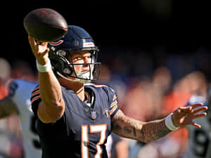 Quarterback Throwing Football Action Wallpaper