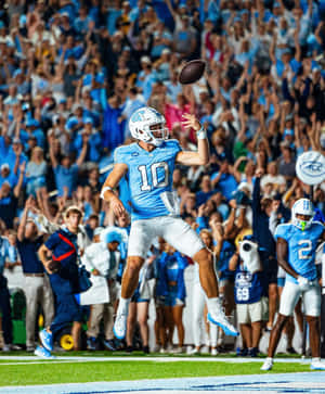 Quarterback Throwing Football During Game Wallpaper