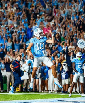 Quarterback Throwing Football During Game Wallpaper