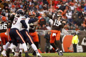 Quarterback Throwing Football During Game Wallpaper