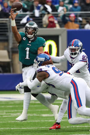 Quarterback Throwing Football During Game Wallpaper