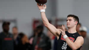 Quarterback Throwing Football Pro Day Wallpaper