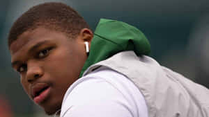 Quinnen Williams Profilewith Earphones Wallpaper