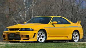 R33 Gtr Yellow Low Rise On Field Wallpaper