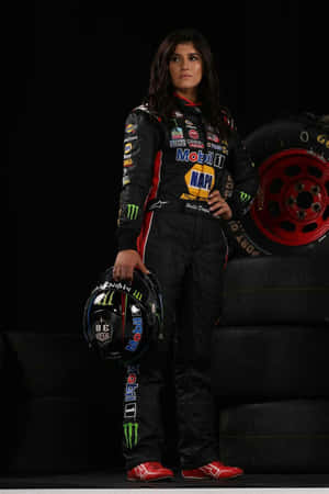 Racing Driver Portraitwith Helmetand Tires Wallpaper